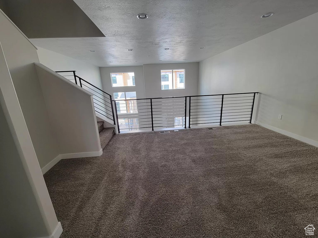 Carpeted spare room featuring recessed lighting and a textured ceiling