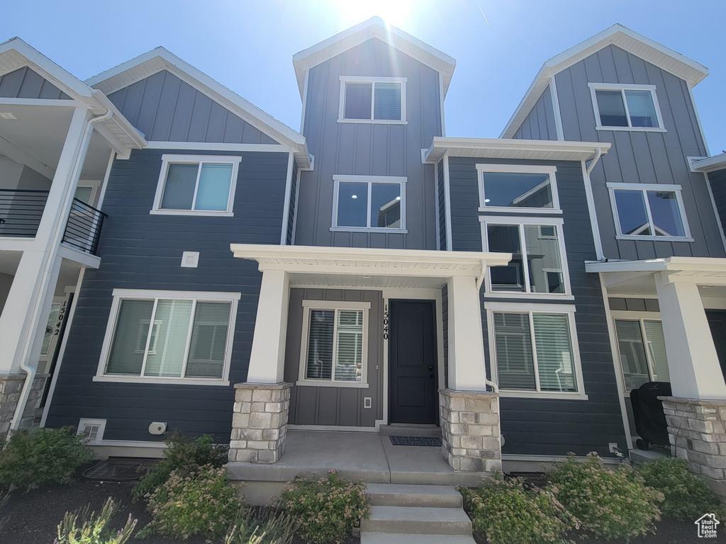 View of front facade with board and batten siding and stone siding