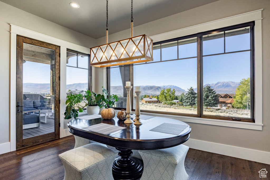 Dining room with a mountain view, dark wood finished floors, healthy amount of natural light, and recessed lighting