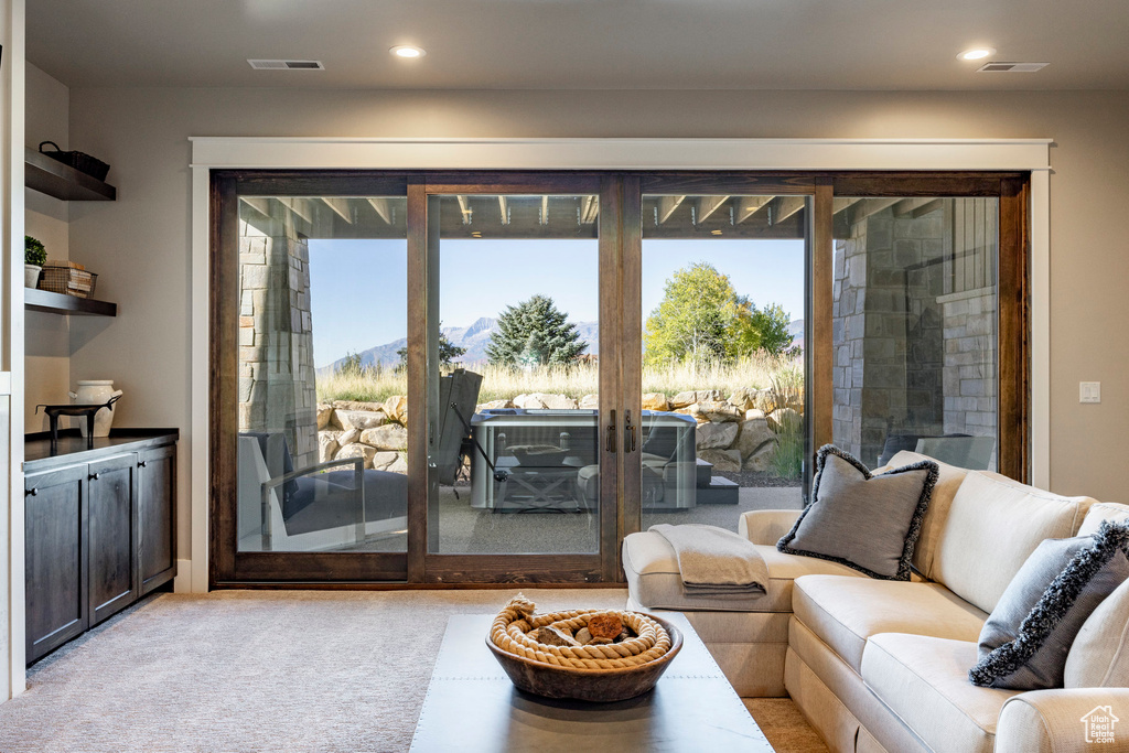 Carpeted living room with recessed lighting