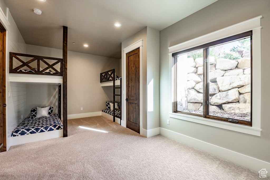 Carpeted bedroom with recessed lighting and baseboards