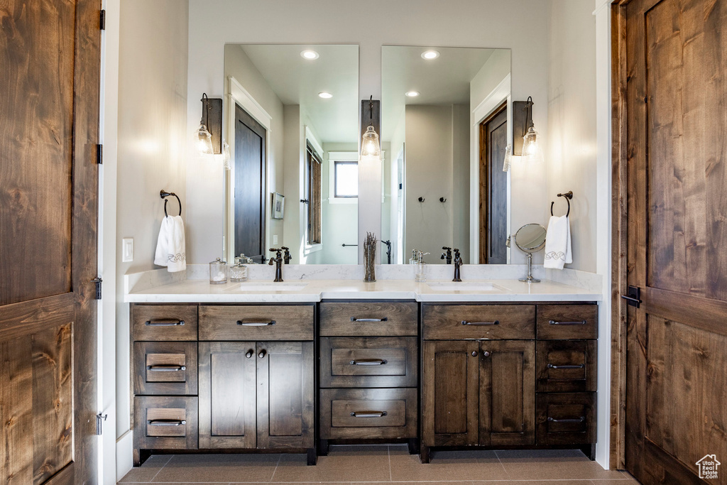 Full bathroom with double vanity, recessed lighting, and tile patterned flooring