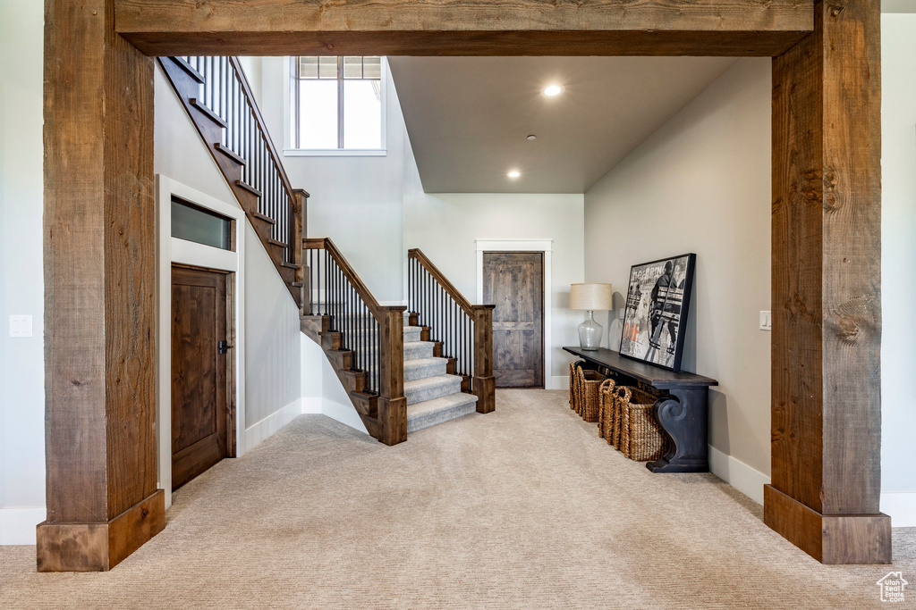 Entryway with carpet, stairs, and recessed lighting