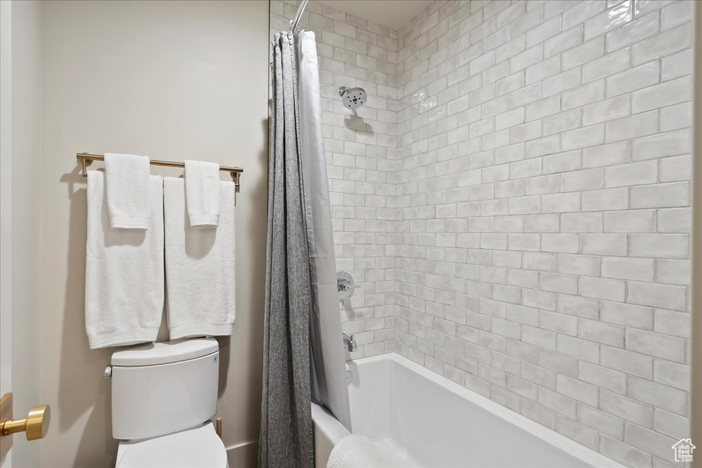Bathroom with toilet and shower / tub combo
