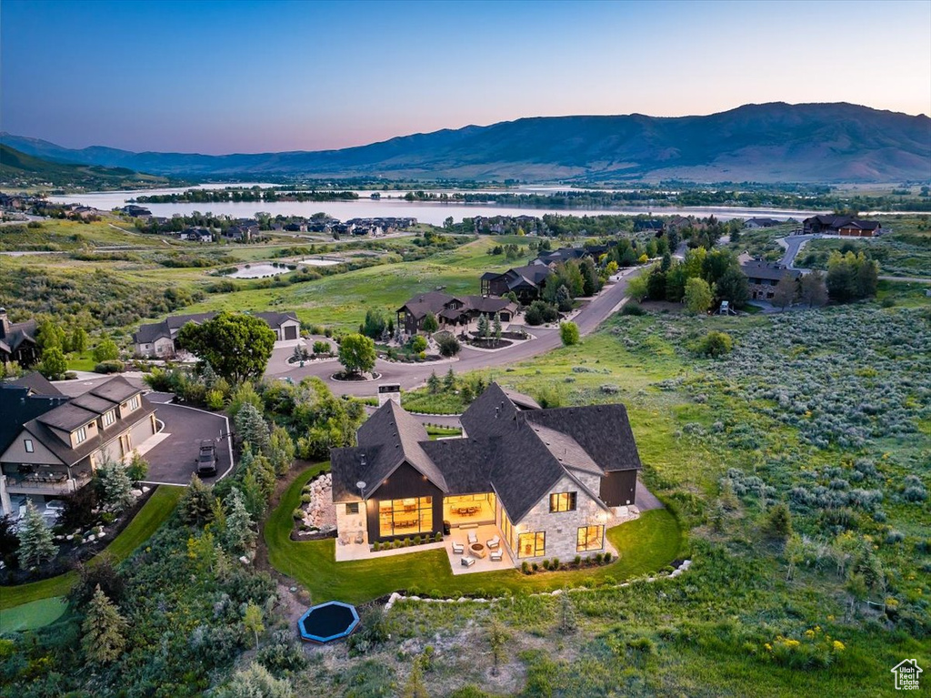 Aerial view of property and surrounding area featuring a water and mountain view