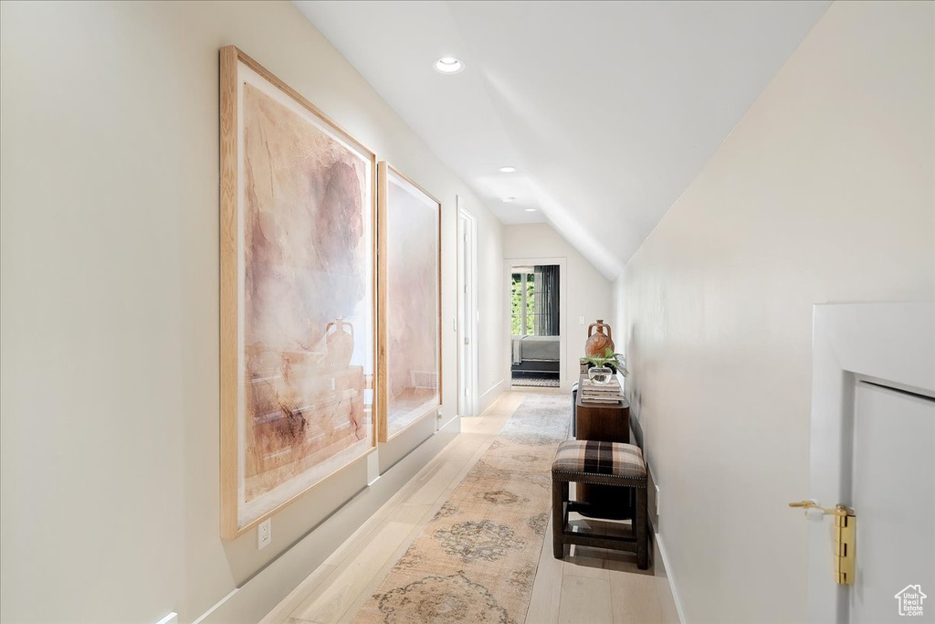 Hall with recessed lighting and lofted ceiling
