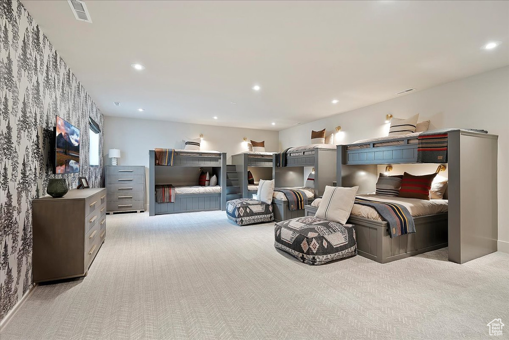 Bedroom with light colored carpet, recessed lighting, and wallpapered walls