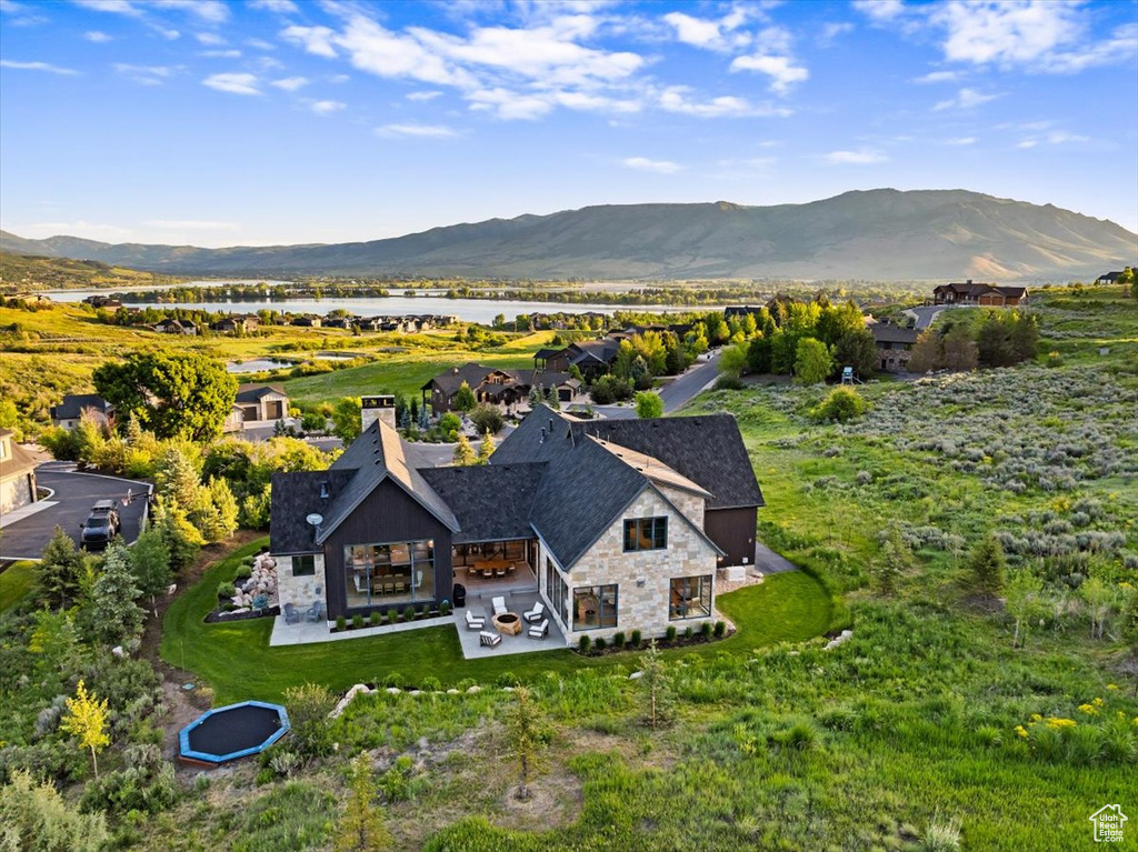 View from above of property with a water and mountain view