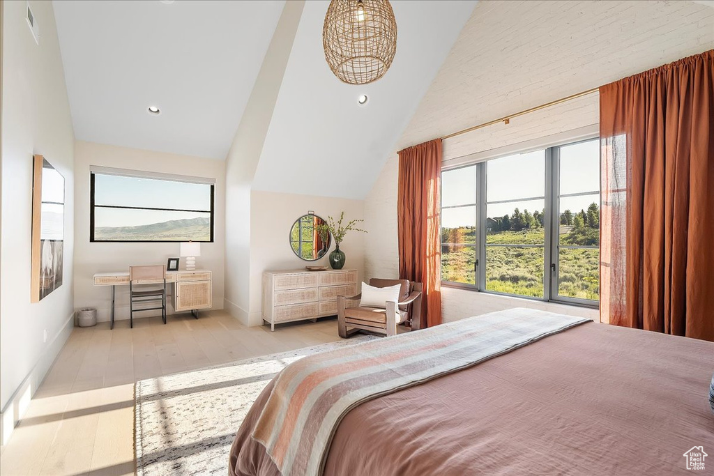 Bedroom with lofted ceiling, wood finished floors, and recessed lighting