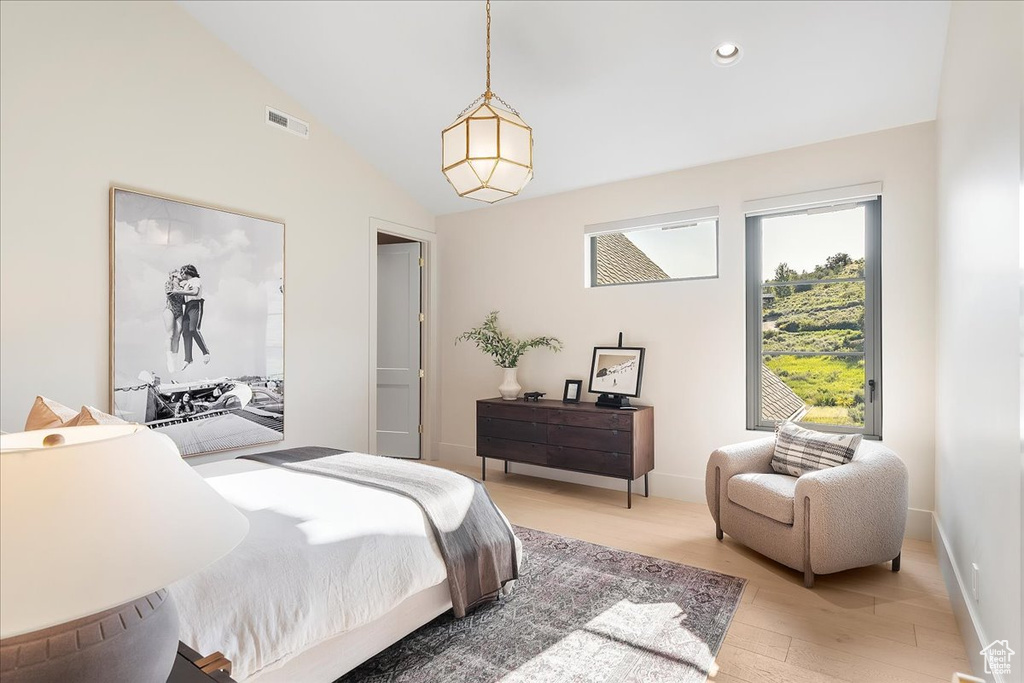 Bedroom with light wood-style flooring, vaulted ceiling, and recessed lighting