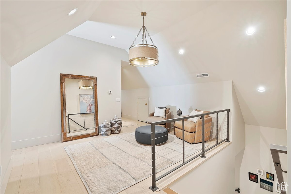 Additional living space featuring lofted ceiling and recessed lighting