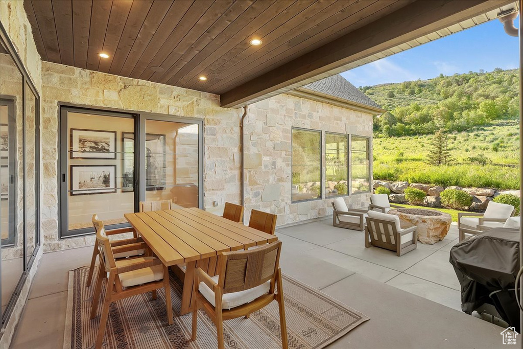 View of patio with an outdoor fire pit