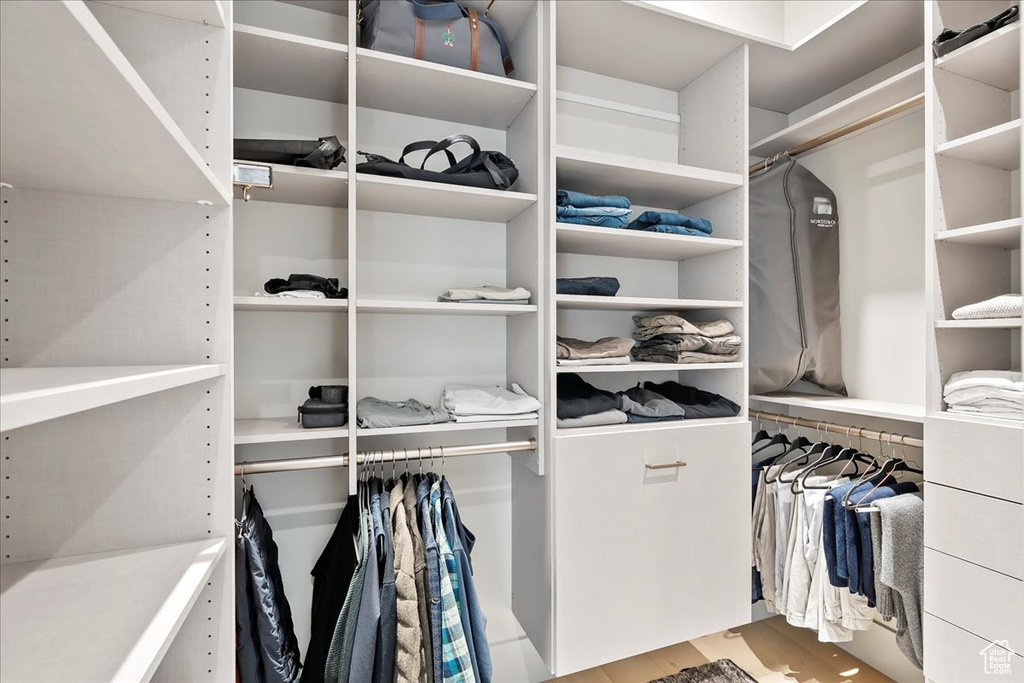 Spacious closet with light wood-style flooring