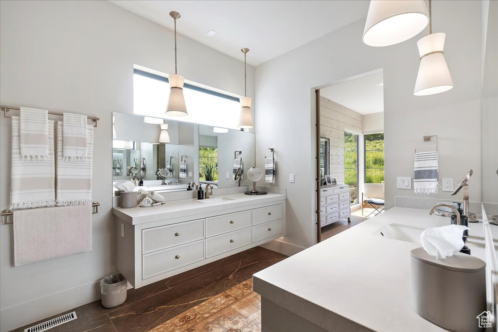 Full bathroom featuring vanity, wood finished floors, and a towering ceiling