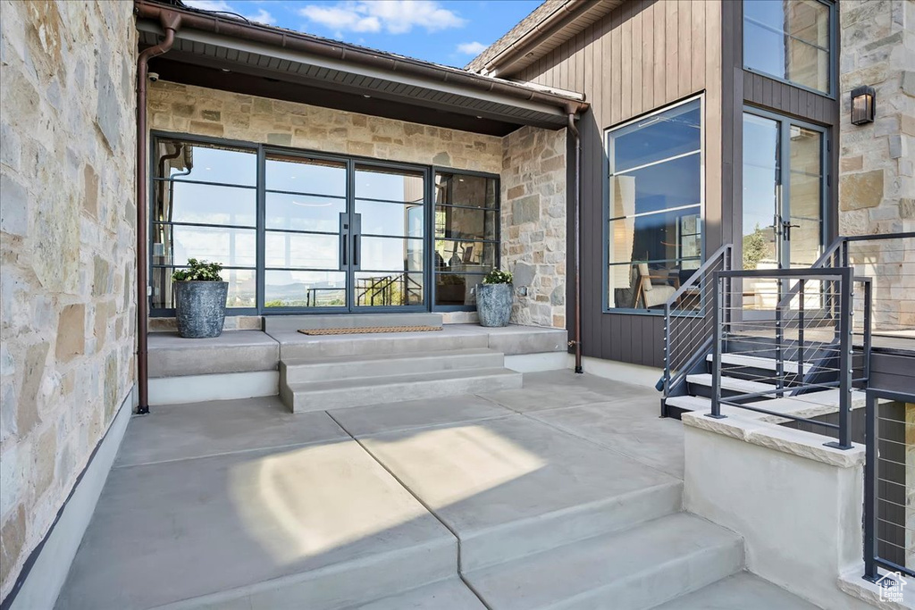 Property entrance featuring stone siding and french doors