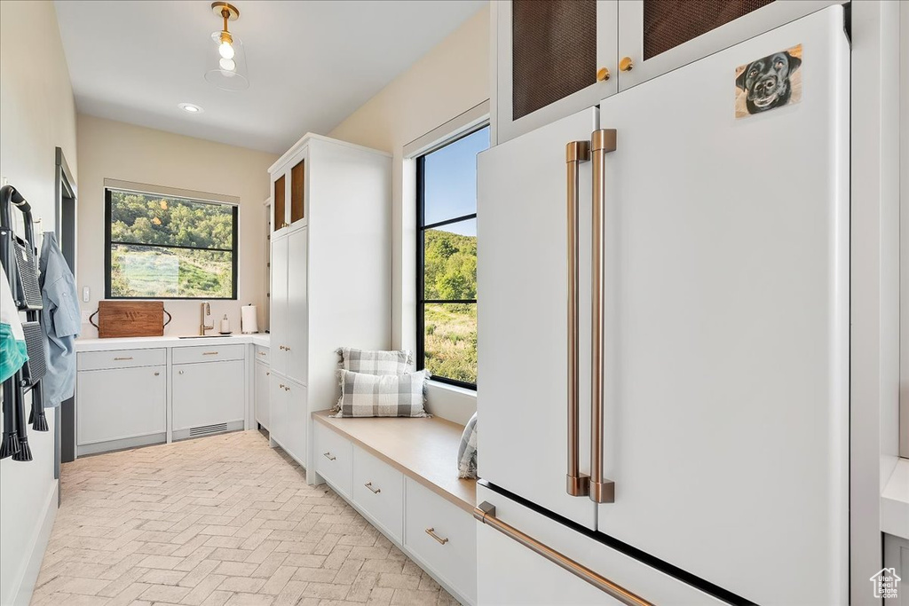 Mudroom featuring brick patterned flooring, healthy amount of natural light, and recessed lighting