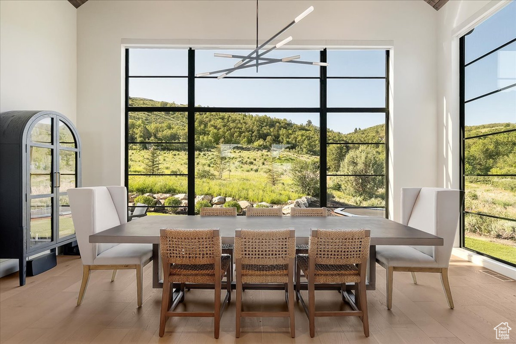 Dining area with a chandelier and light wood-style floors