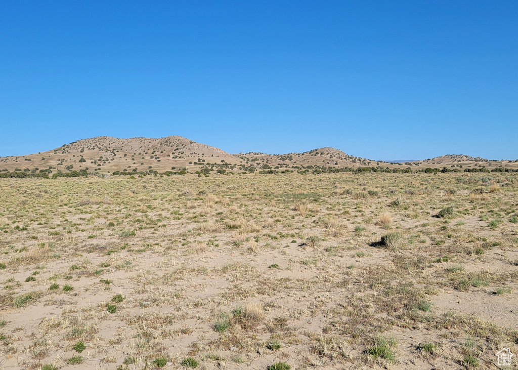 View of mountain backdrop featuring a desert landscape