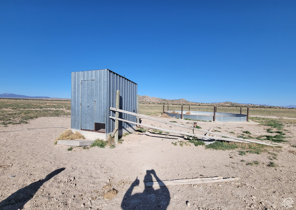 View of outdoor structure featuring a mountain view and a view of rural / pastoral area
