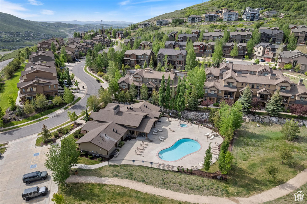Aerial view of property\'s location featuring nearby suburban area and a mountain backdrop