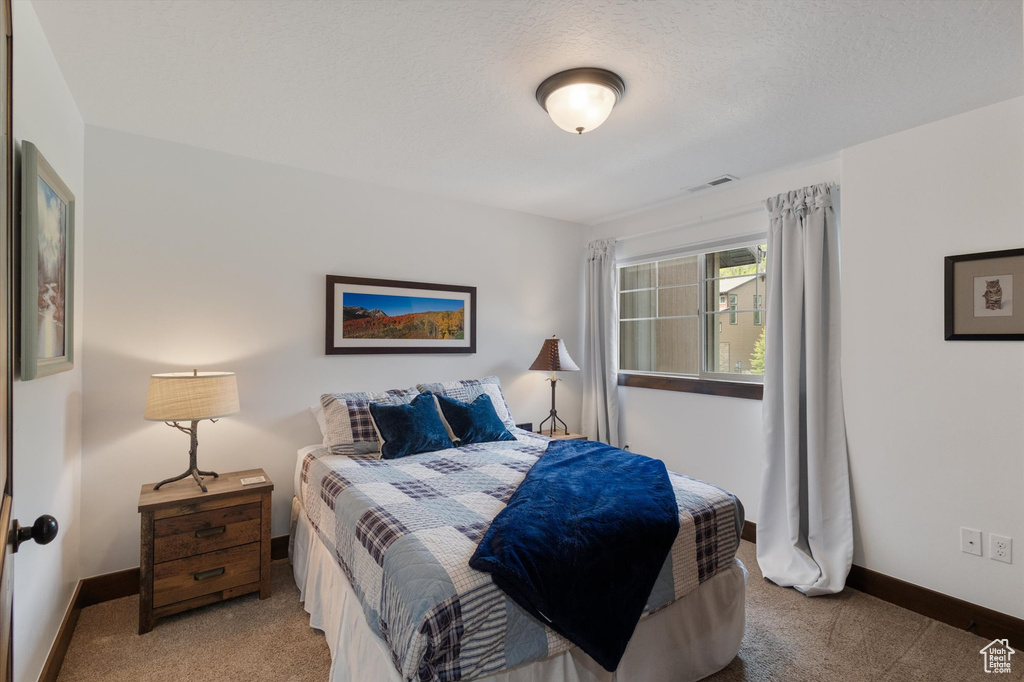 Bedroom with carpet and baseboards