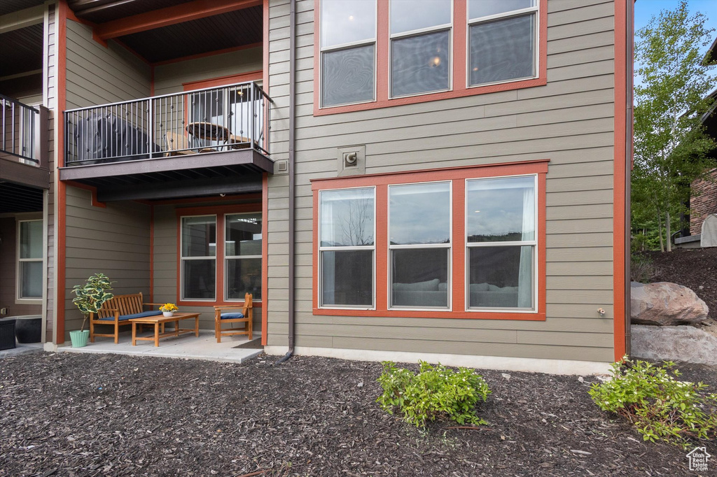 Back of property with a balcony
