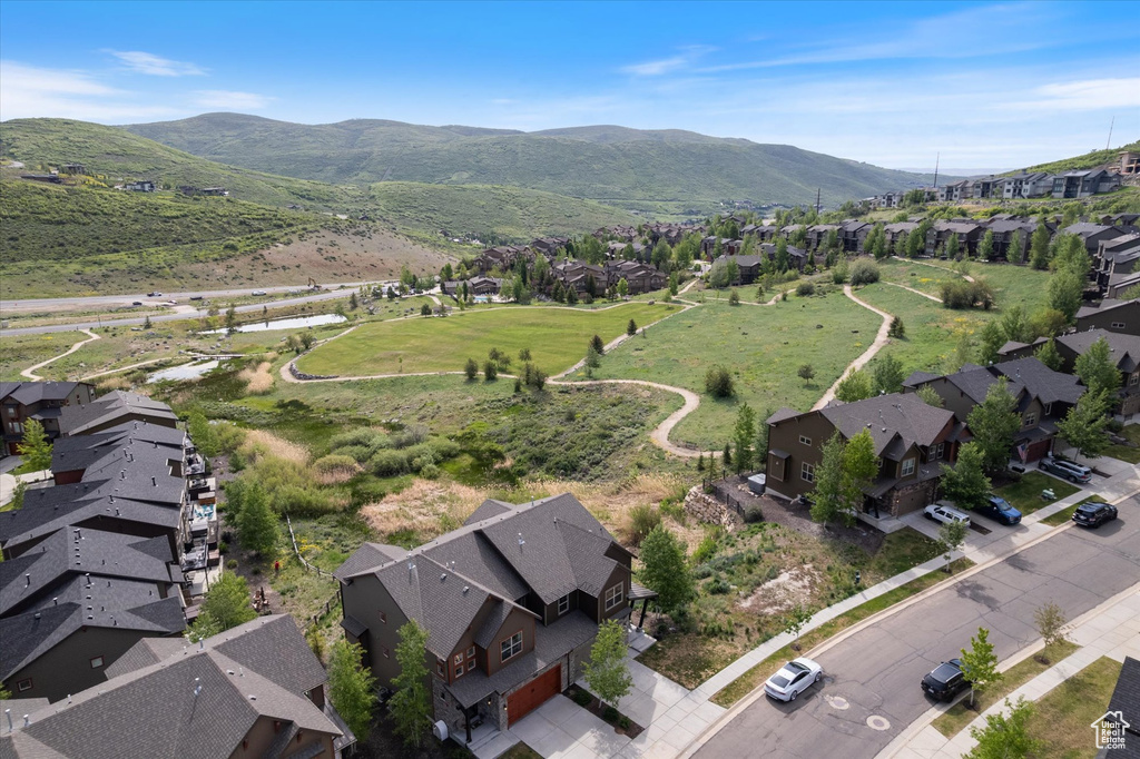 Aerial view of property\'s location featuring nearby suburban area and a mountainous background