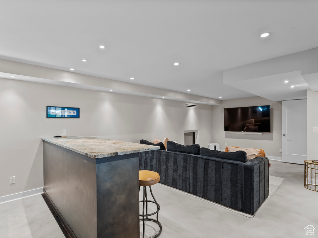 Bar area featuring recessed lighting and concrete flooring