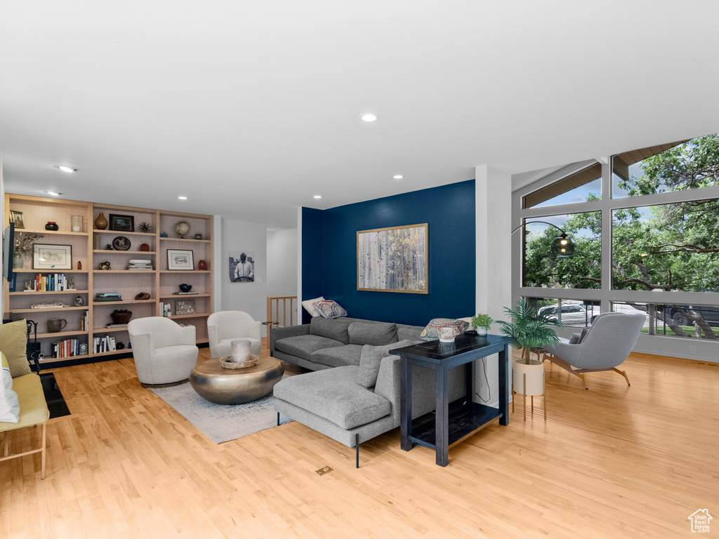 Living area with wood finished floors and recessed lighting