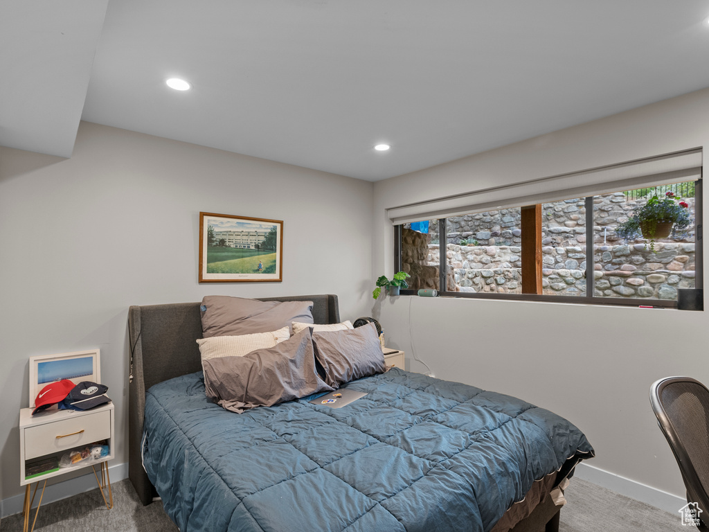 Carpeted bedroom with recessed lighting