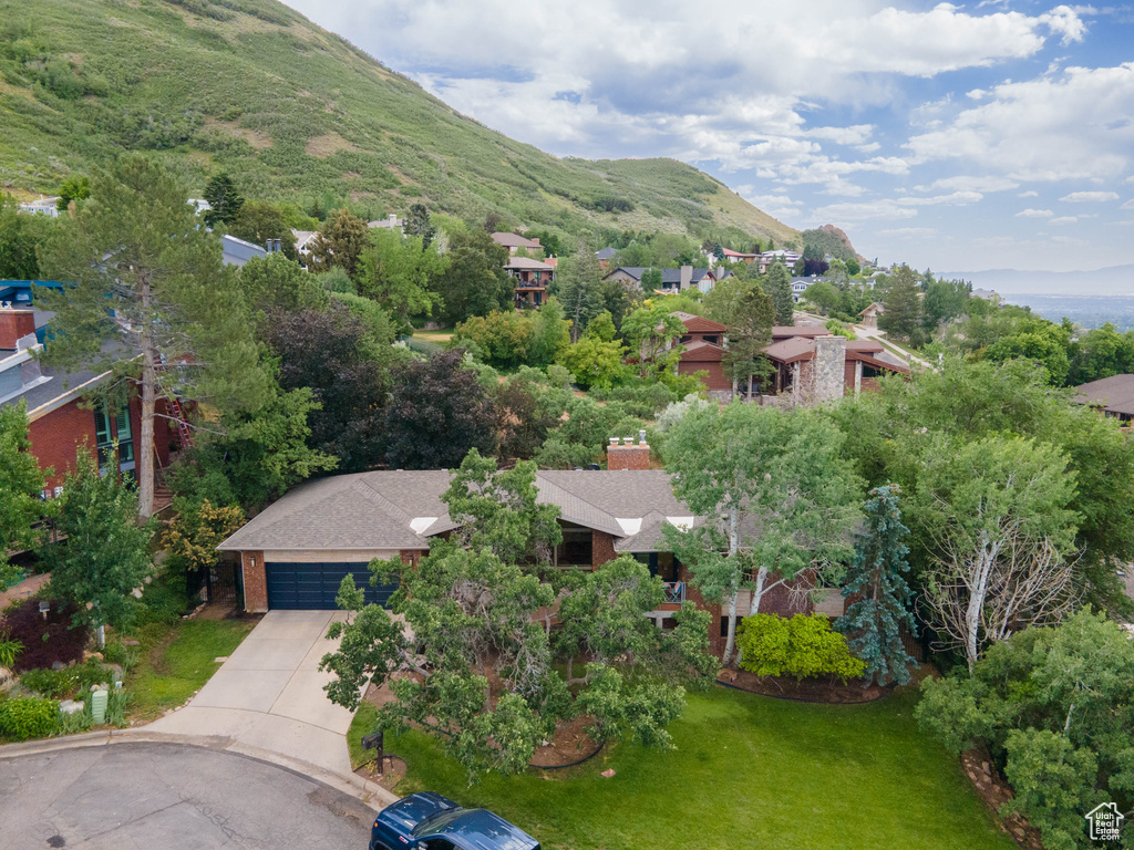 Aerial view of residential area featuring a mountainous background