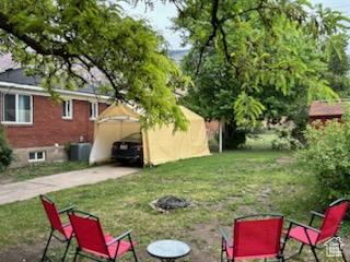 View of green lawn featuring driveway