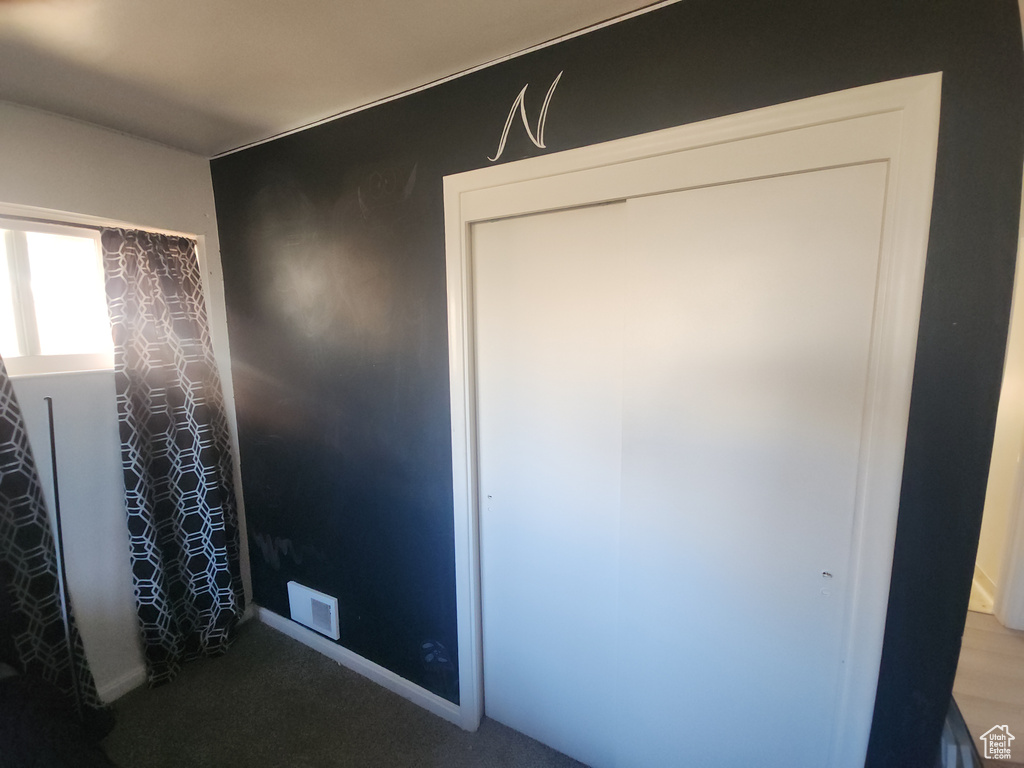 Unfurnished bedroom featuring carpet floors and baseboards