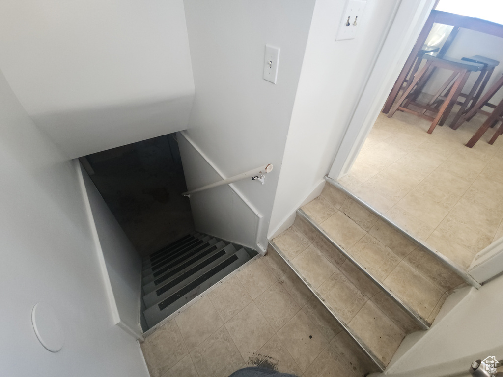 Stairway featuring tile patterned floors