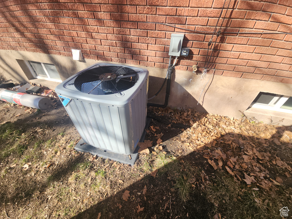 Exterior view of a central air condition unit and brick siding