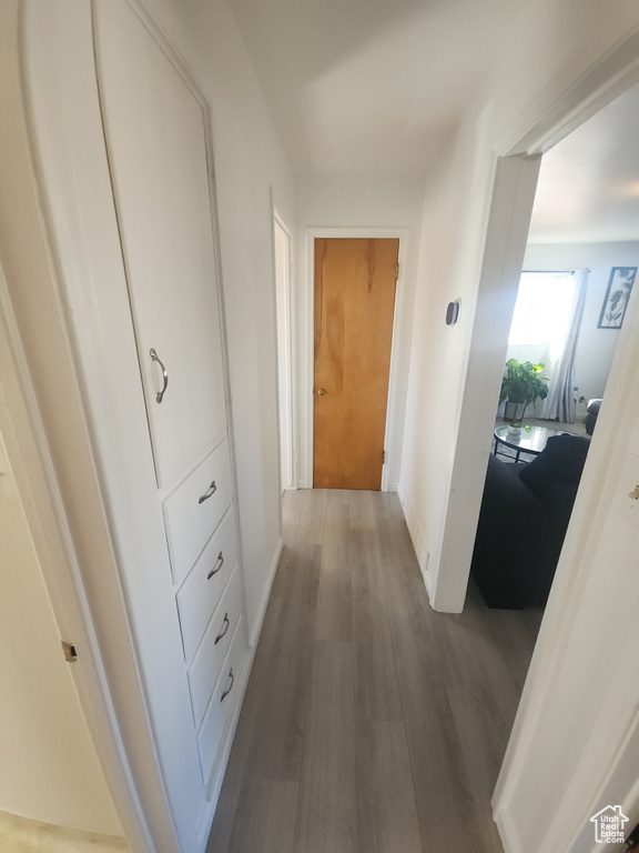 Hall featuring wood finished floors and baseboards