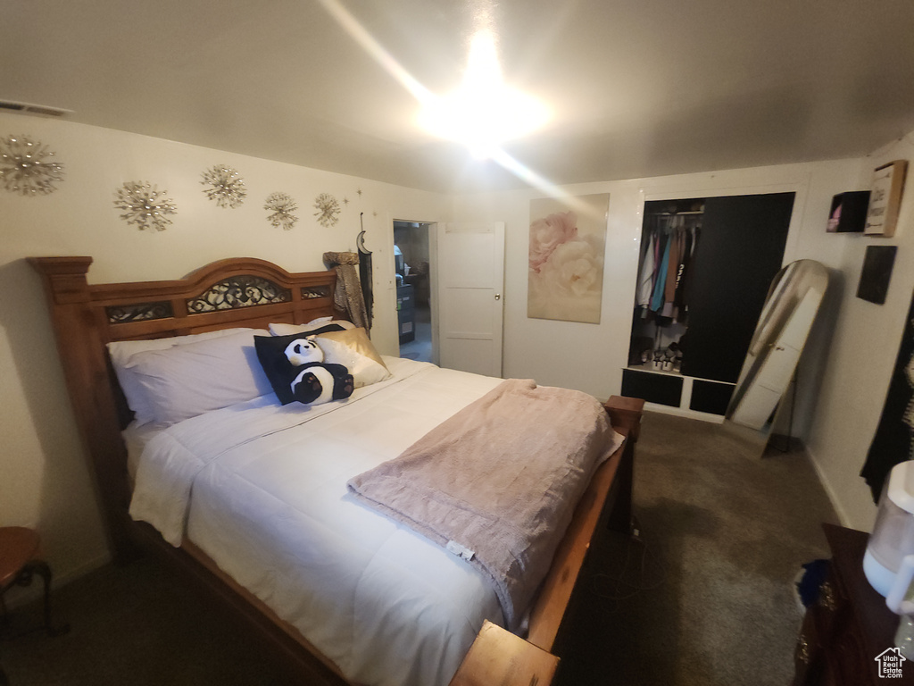 Carpeted bedroom with a closet