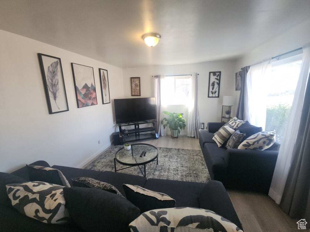 Living area with wood finished floors and healthy amount of natural light
