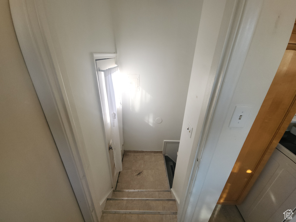 Stairway featuring tile patterned floors