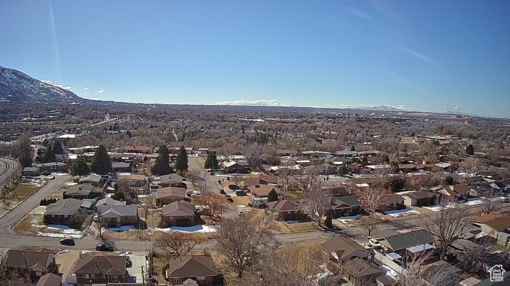 Aerial perspective of suburban area featuring a mountain backdrop