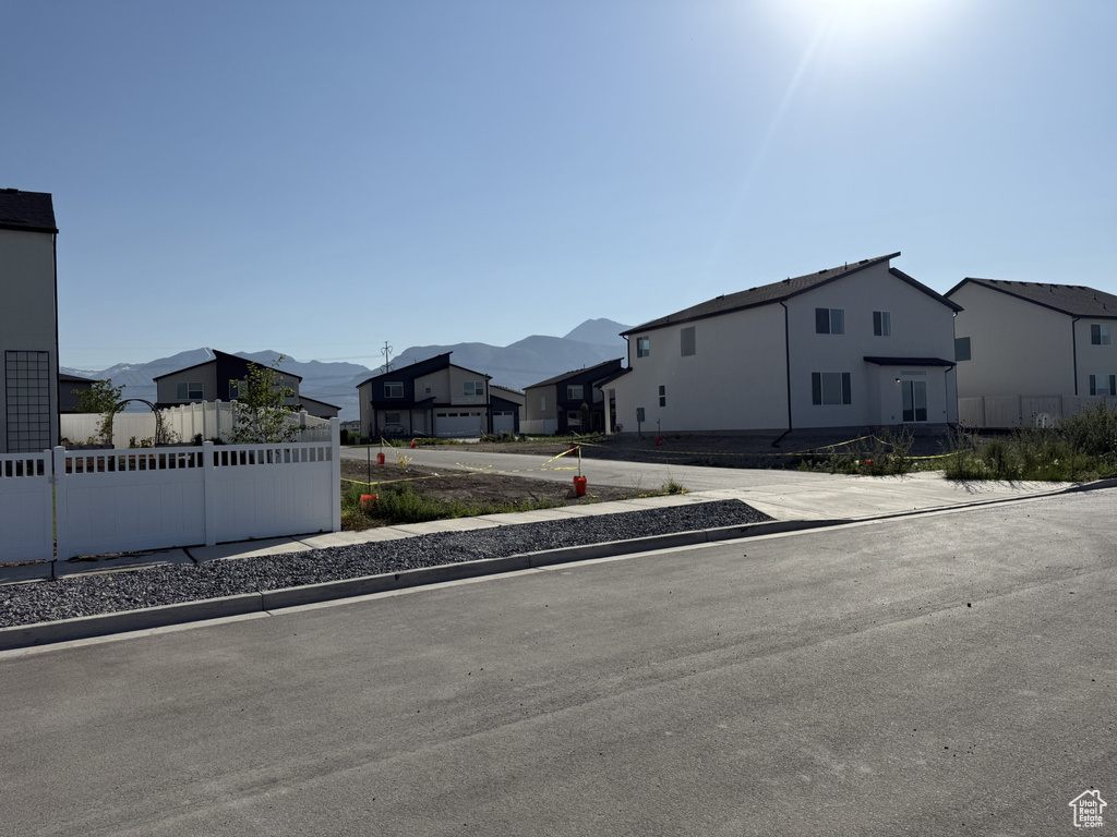 View of front of home featuring a residential view and a mountain view