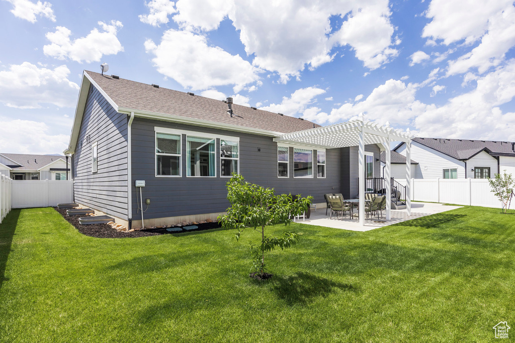 Back of house with a pergola, a fenced backyard, a patio area, and roof with shingles