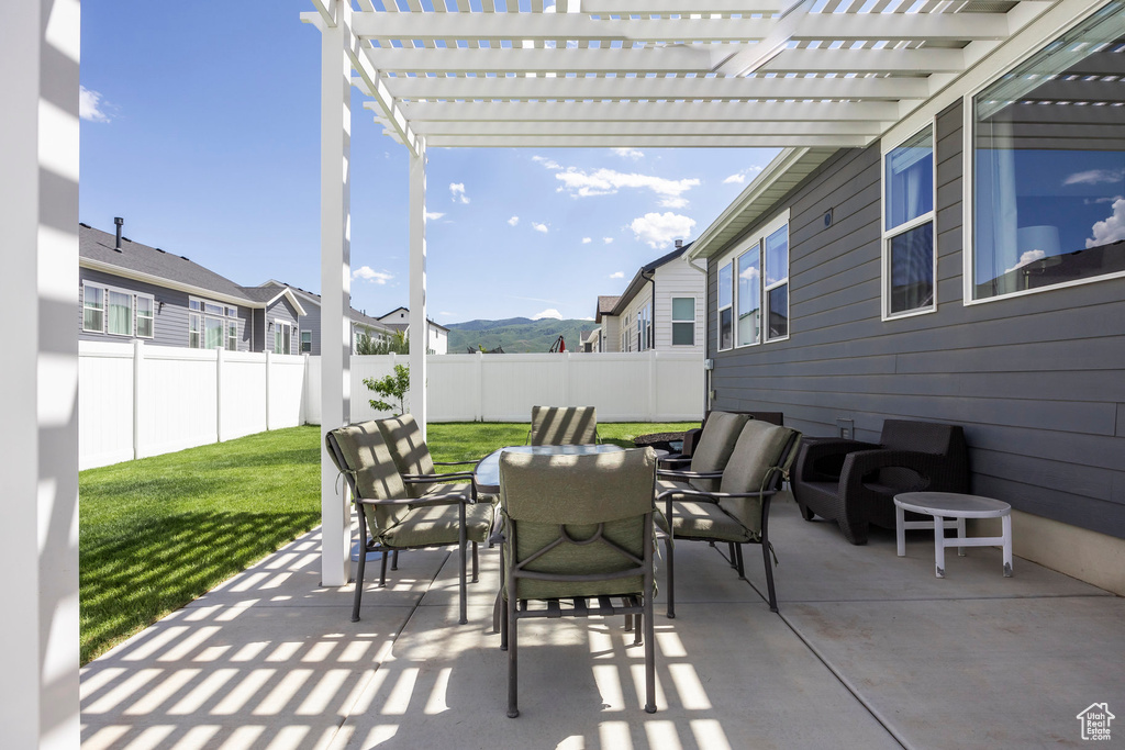Fenced backyard featuring outdoor dining area, a pergola, and a patio