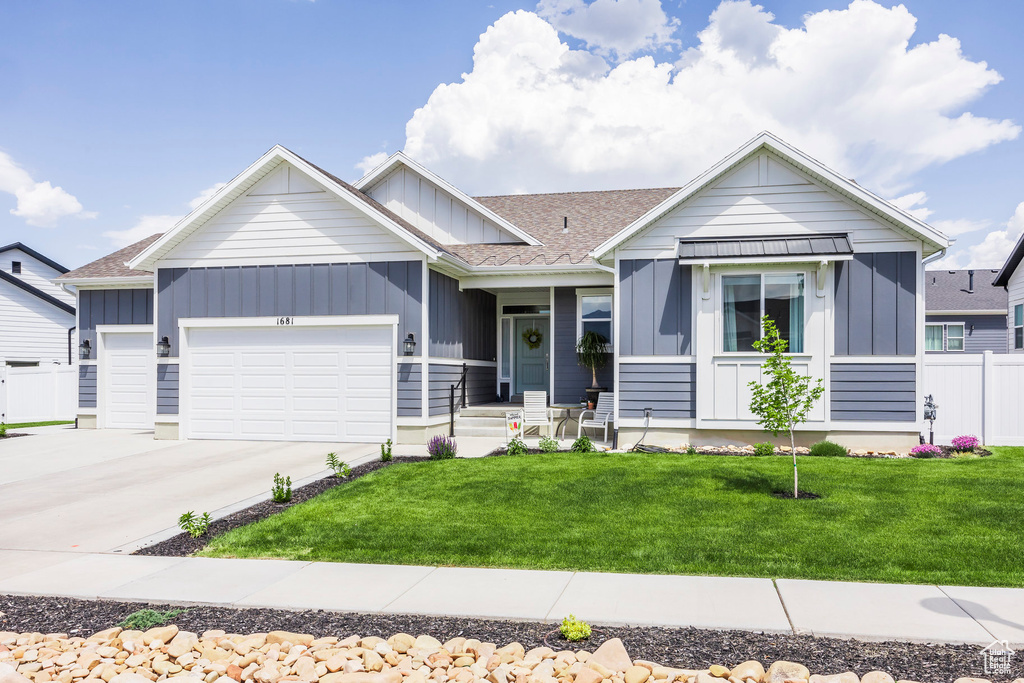 Ranch-style home with board and batten siding, a garage, driveway, and a shingled roof