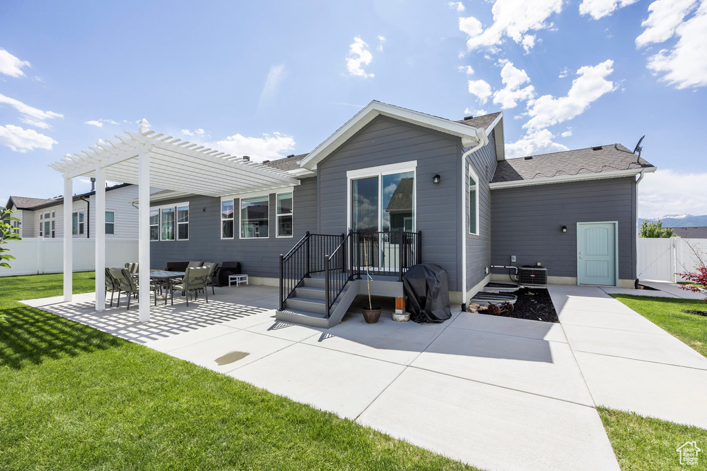Back of property with a patio and a pergola