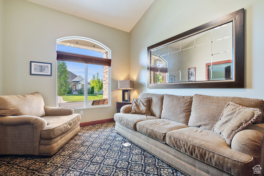Living room with vaulted ceiling and baseboards