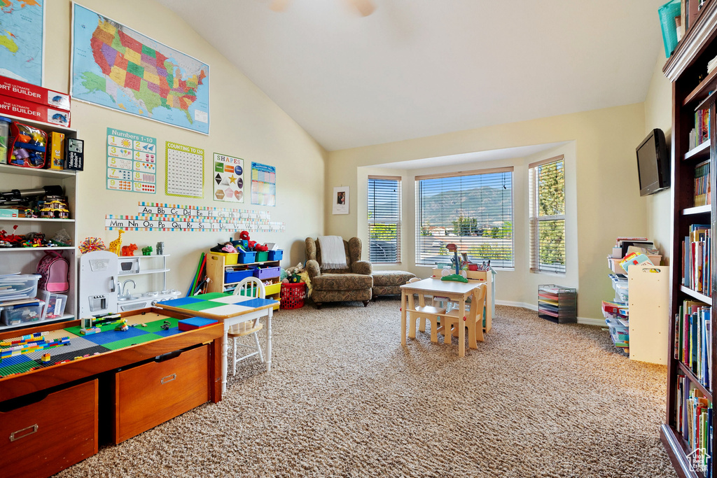 Playroom with vaulted ceiling and carpet floors