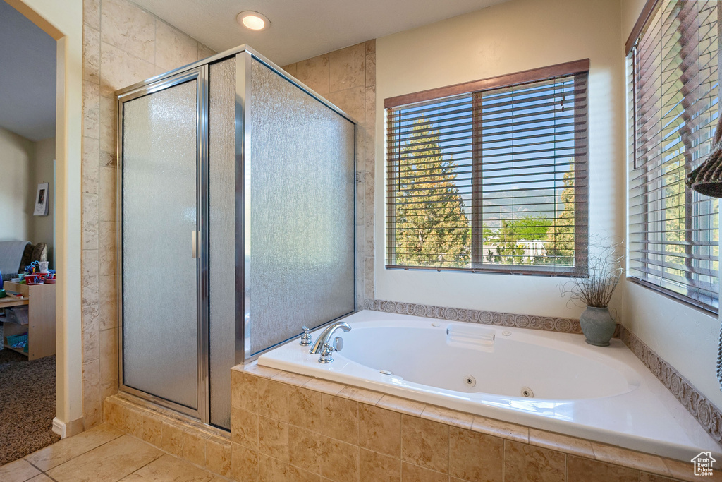 Full bath featuring a shower stall, tile patterned flooring, and a jetted tub