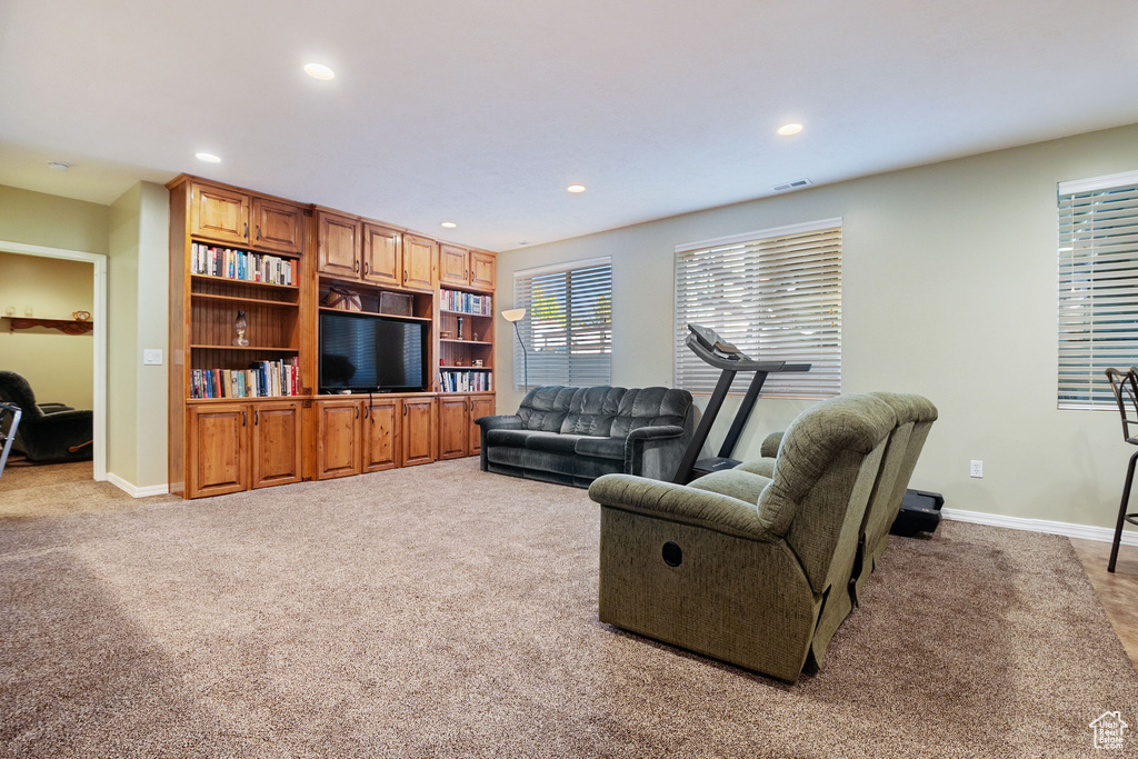 Living room with light colored carpet and recessed lighting