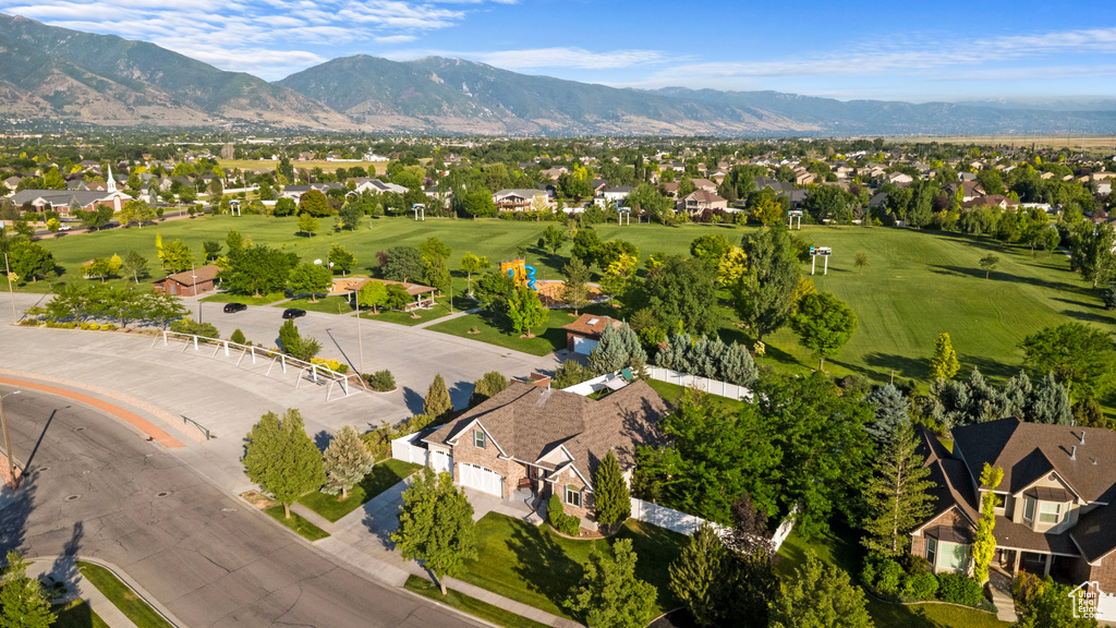 Aerial perspective of suburban area with mountains and a golf course